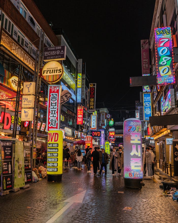Bustling Seoul street scene with neon signs and people exploring Korea's vibrant nightlife.